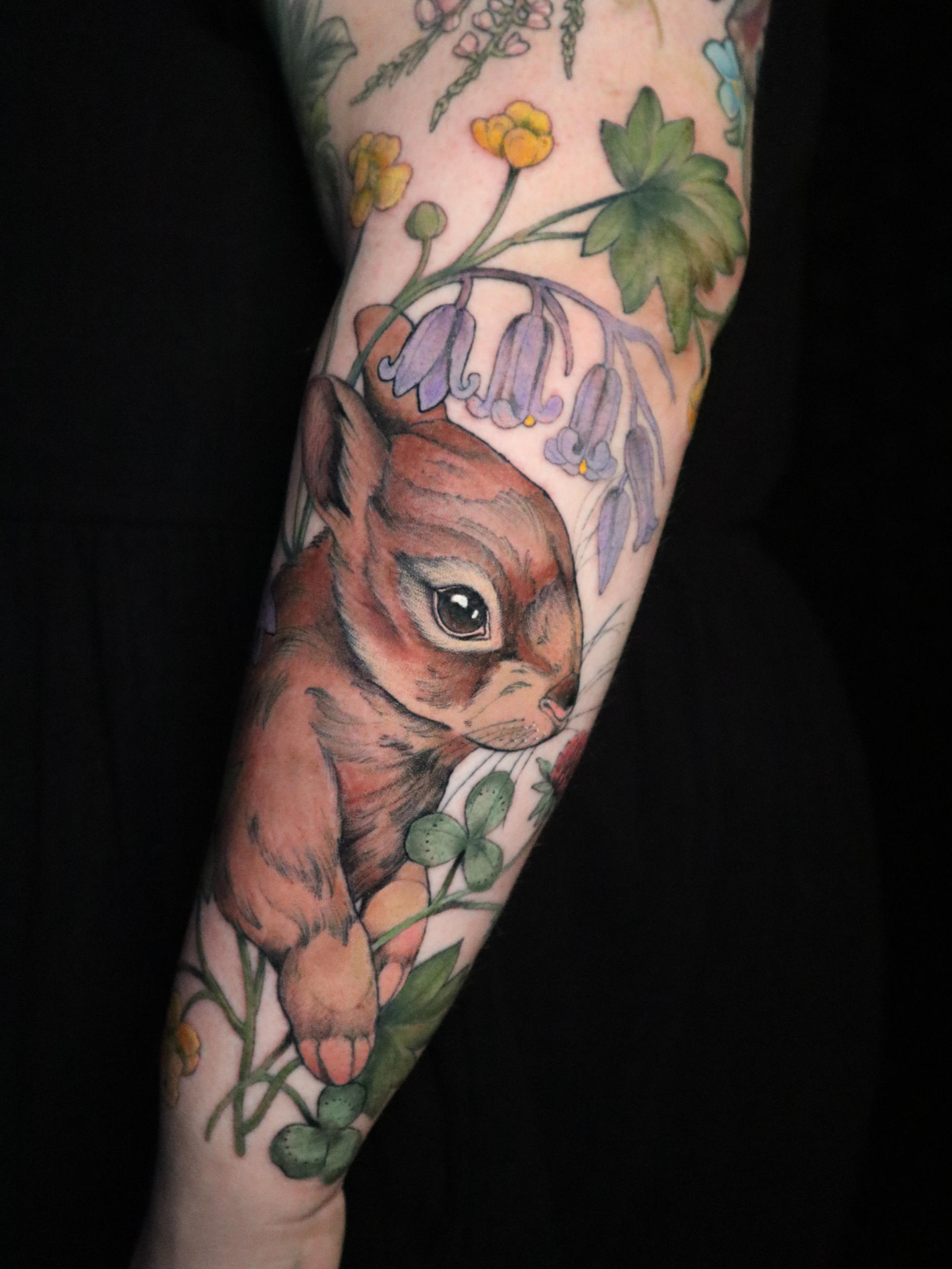 Tattoo of Brown bunny rabbit with British wild flowers